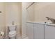 Full bathroom featuring a toilet and adjacent white washer and dryer at 4633 E Chaparosa Way, Cave Creek, AZ 85331