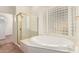 Bathroom features a glass enclosed shower, soaking tub, and light-filled glass block window at 4633 E Chaparosa Way, Cave Creek, AZ 85331