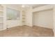 Bright bedroom with natural light from the window, built-in shelving, and a ceiling fan at 4633 E Chaparosa Way, Cave Creek, AZ 85331