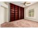 Bedroom with a ceiling fan, a window and a floor to ceiling wooden bookcase at 4633 E Chaparosa Way, Cave Creek, AZ 85331