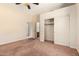 Bedroom with ceiling fan, access to bathroom and walk-in closet at 4633 E Chaparosa Way, Cave Creek, AZ 85331