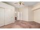 Carpeted bedroom featuring a ceiling fan, an ensuite bathroom, and a closet at 4633 E Chaparosa Way, Cave Creek, AZ 85331