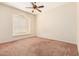 Bedroom features a ceiling fan, neutral paint, and a window with a view at 4633 E Chaparosa Way, Cave Creek, AZ 85331