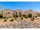 Beautiful single-story home featuring a well-manicured desert landscape and a decorative stone dry river at 4633 E Chaparosa Way, Cave Creek, AZ 85331