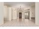 Open living area with tile flooring and a decorative chandelier and a glimpse into another room at 4633 E Chaparosa Way, Cave Creek, AZ 85331