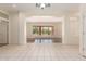 Spacious living room with tile floors, a large window, and a view to the outdoor pool at 4633 E Chaparosa Way, Cave Creek, AZ 85331