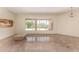 Bright living room with tile floors, a large window view to the backyard pool and desert landscape at 4633 E Chaparosa Way, Cave Creek, AZ 85331