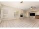 Open living room with a fireplace and tile floors at 4633 E Chaparosa Way, Cave Creek, AZ 85331
