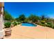 Inviting backyard pool surrounded by lush landscaping, mature trees, and patio space at 4633 E Chaparosa Way, Cave Creek, AZ 85331