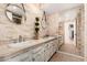 Bathroom showcasing dual sinks, stone accent wall and luxury finishes at 4833 N 38Th St, Phoenix, AZ 85018