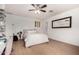 Clean bedroom with a white bed, ceiling fan, and bright natural light at 4833 N 38Th St, Phoenix, AZ 85018