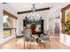 Elegant dining room showcases a chandelier, round table with blue chairs, and a dark wood hutch at 4833 N 38Th St, Phoenix, AZ 85018
