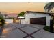 Spacious two-car garage with brick-lined driveway and landscaped surroundings at 4833 N 38Th St, Phoenix, AZ 85018