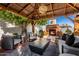 Outdoor brick fireplace underneath a wooden gazebo with outdoor furniture for cozy gatherings at 4833 N 38Th St, Phoenix, AZ 85018