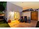 Backyard patio features two chaise lounges, an artificial lawn, and door to the home interior at 4833 N 38Th St, Phoenix, AZ 85018
