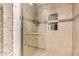 Shower featuring tiled walls, built-in niches, and a glass door at 4833 N 38Th St, Phoenix, AZ 85018