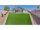 Expansive backyard featuring lush artificial grass, offering a serene outdoor space at 486 E Bamboo Ln, San Tan Valley, AZ 85140