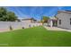 Large backyard with artificial grass, providing a perfect area for recreation and leisure at 486 E Bamboo Ln, San Tan Valley, AZ 85140