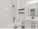 Modern bathroom with white subway tiles, a dark sink and wood shelves at 486 E Bamboo Ln, San Tan Valley, AZ 85140