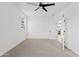 Bright bedroom features neutral carpet, white walls, and bathroom access at 486 E Bamboo Ln, San Tan Valley, AZ 85140