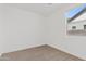 Bright, carpeted bedroom with a window, creating a cozy and inviting space at 486 E Bamboo Ln, San Tan Valley, AZ 85140