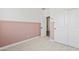 Bedroom featuring pink wainscoting, carpet, and a closet for ample storage at 486 E Bamboo Ln, San Tan Valley, AZ 85140