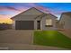 Charming home with manicured lawn, brick driveway, and a covered front porch at 486 E Bamboo Ln, San Tan Valley, AZ 85140