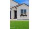 Close up of house with large window with flower box and lush green lawn at 486 E Bamboo Ln, San Tan Valley, AZ 85140