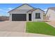 Charming single-story home featuring a dark gray garage door and a well-manicured lawn at 486 E Bamboo Ln, San Tan Valley, AZ 85140