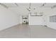 Clean garage with a light gray floor and overhead storage at 486 E Bamboo Ln, San Tan Valley, AZ 85140