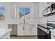 Bright kitchen with white cabinets, modern appliances, and ample counter space at 486 E Bamboo Ln, San Tan Valley, AZ 85140