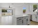 Modern kitchen with large island, stainless steel appliances, and access to the patio at 486 E Bamboo Ln, San Tan Valley, AZ 85140