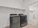Modern laundry room boasts new machines, white shelving, and tile flooring at 486 E Bamboo Ln, San Tan Valley, AZ 85140