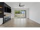 Inviting living room with a sleek fireplace, sliding glass doors, and wood-look floors at 486 E Bamboo Ln, San Tan Valley, AZ 85140