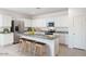 Bright kitchen with stainless steel appliances, a center island, and bar stool seating at 4940 S 106Th Ln, Tolleson, AZ 85353