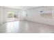 Spacious living room with tile floors and natural light from multiple windows at 4940 S 106Th Ln, Tolleson, AZ 85353