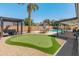 Large backyard featuring pool, putting green, patio and grill area at 4944 W Vista Ave, Glendale, AZ 85301