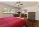 Well-lit bedroom features a ceiling fan, closet, and a view of the yard at 4944 W Vista Ave, Glendale, AZ 85301