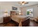 Bedroom features a ceiling fan, lamps, and natural light at 4944 W Vista Ave, Glendale, AZ 85301