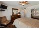 Bright bedroom with a ceiling fan, dresser, and comfortable seating area at 4944 W Vista Ave, Glendale, AZ 85301
