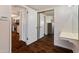 View of hallway leading into a bedroom, showing wood-look floors and a mirror at 4944 W Vista Ave, Glendale, AZ 85301