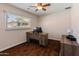 Neutral-toned bedroom featuring wood-look floors, a window, and furniture at 4944 W Vista Ave, Glendale, AZ 85301