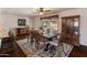 Elegant dining room with a large wooden table, seating for eight, and natural light at 4944 W Vista Ave, Glendale, AZ 85301