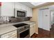 Updated kitchen boasts stainless steel appliances, modern backsplash, and ample counter space at 4944 W Vista Ave, Glendale, AZ 85301