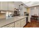 Spacious kitchen with stone countertops, a stainless steel dishwasher, and natural light at 4944 W Vista Ave, Glendale, AZ 85301