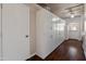 Laundry room with ample storage, a white door, and wood-look floors at 4944 W Vista Ave, Glendale, AZ 85301