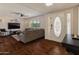 Cozy living room with hardwood floors, a ceiling fan, and a comfortable gray sectional sofa at 4944 W Vista Ave, Glendale, AZ 85301