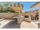 Outdoor kitchen includes built-in bar table and barbecue grill at 4944 W Vista Ave, Glendale, AZ 85301