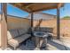 Cozy covered patio with comfortable seating and a fire pit table at 4944 W Vista Ave, Glendale, AZ 85301