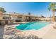 Beautiful backyard featuring a diving pool, outdoor kitchen, and shaded seating at 4944 W Vista Ave, Glendale, AZ 85301